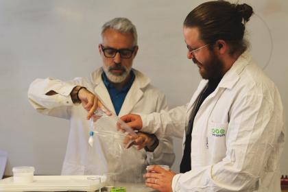 Två pedagoger som gör ett kemiexperiment tillsammans. 