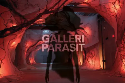 EN skugga av en parasit bakom en text.